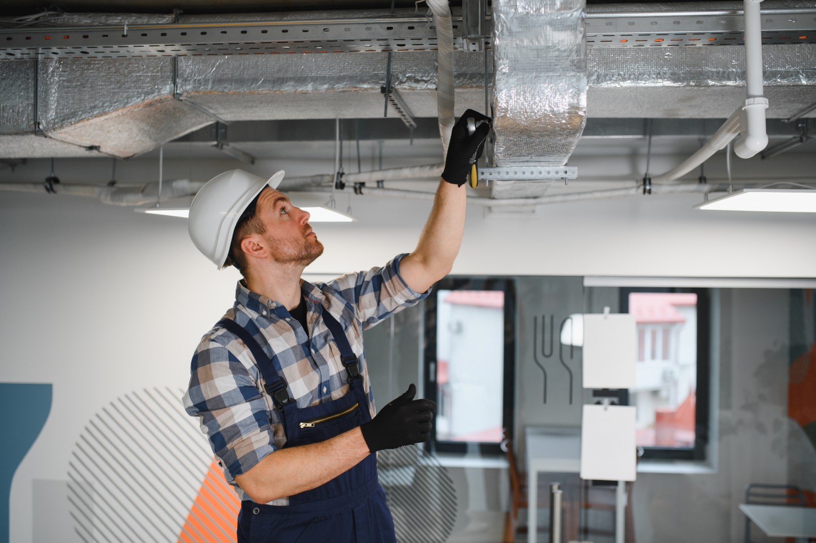 Worker for an HVAC company looking over a new HVAC system